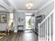 Welcoming foyer with wood floors, stairway, hall tree and ample natural light at 2003 Trigger Dr, Indian Trail, NC 28079