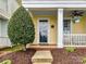 Inviting front porch with ceiling fan, room for seating, and manicured landscaping at 2003 Trigger Dr, Indian Trail, NC 28079