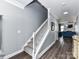 Hallway with staircase and hardwood floors, leading to a comfortable living area at 2003 Trigger Dr, Indian Trail, NC 28079
