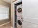 A convenient laundry room with stacked washer and dryer maximizing space efficiency at 2003 Trigger Dr, Indian Trail, NC 28079