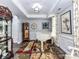 Elegant living room with a baby grand piano, wainscotting, and stylish decor at 2003 Trigger Dr, Indian Trail, NC 28079