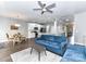 Cozy living room featuring a blue sofa, ceiling fan, and open layout connected to the kitchen at 2003 Trigger Dr, Indian Trail, NC 28079