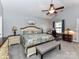 Spacious main bedroom features a ceiling fan, and an ensuite workspace with natural light at 2003 Trigger Dr, Indian Trail, NC 28079