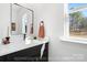 Modern bathroom featuring a sleek vanity, stylish mirror, and bright natural lighting from the window at 213 Knot St, Shelby, NC 28150