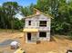 New construction in progress, showing the framing of a modern two-story home with a unique roofline at 213 Knot St, Shelby, NC 28150
