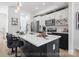 Modern kitchen with white cabinetry, stainless steel appliances, and a black island with bar seating at 213 Knot St, Shelby, NC 28150