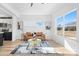 Bright living room featuring a large window, stylish decor, and a glimpse of the modern kitchen at 213 Knot St, Shelby, NC 28150
