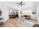 Open-concept living room with hardwood floors, modern furnishings, and sleek kitchen in background at 213 Knot St, Shelby, NC 28150