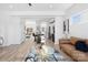 Spacious living area with a modern kitchen view, stylish furniture, and hardwood flooring throughout at 213 Knot St, Shelby, NC 28150