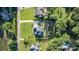 A bird's eye view of a home with lush gardens, a long driveway, and mature trees on a verdant lot at 230 Washam Rd, Mooresville, NC 28117