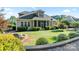 Inviting backyard with a stone fire pit, lush landscaping, and a cozy screened-in porch at 230 Washam Rd, Mooresville, NC 28117