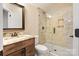 Modern bathroom featuring a sleek vanity, framed mirror, and a tiled walk-in shower at 230 Washam Rd, Mooresville, NC 28117