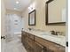 Bright bathroom featuring a double vanity, framed mirrors, and a shower-tub combo at 230 Washam Rd, Mooresville, NC 28117