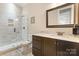 Bathroom featuring a walk-in shower, dark wood cabinet and marble countertop at 230 Washam Rd, Mooresville, NC 28117