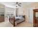Inviting bedroom with a cozy window seat, decorative shelving and a stylish ceiling fan at 230 Washam Rd, Mooresville, NC 28117