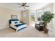 Comfortable bedroom featuring neutral tones, a cozy reading chair, and large bay windows offering ample natural light at 230 Washam Rd, Mooresville, NC 28117