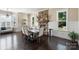 Dining room featuring stone fireplace, wainscotting, and hardwood floors at 230 Washam Rd, Mooresville, NC 28117