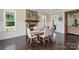Dining room with a stone fireplace, wainscotting, and lots of natural light at 230 Washam Rd, Mooresville, NC 28117