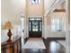 Elegant foyer with a high ceiling, hardwood floors, a decorative rug, and a grand wooden front door at 230 Washam Rd, Mooresville, NC 28117