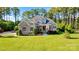 Charming two-story home featuring a lush green lawn, stone accents, and inviting curb appeal surrounded by mature trees at 230 Washam Rd, Mooresville, NC 28117
