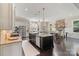 Eat-in kitchen with island, stainless appliances, and stone fireplace in the adjacent dining area at 230 Washam Rd, Mooresville, NC 28117
