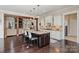 Island kitchen with stone countertops, stainless appliances and hardwood flooring at 230 Washam Rd, Mooresville, NC 28117