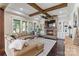 Spacious living room featuring a stone fireplace, built-in shelving, and lots of light at 230 Washam Rd, Mooresville, NC 28117