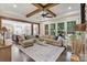 Open concept living room with beamed ceilings, large windows, and dark hardwood floors at 230 Washam Rd, Mooresville, NC 28117