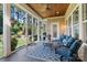 Inviting screened porch with comfortable seating, wood ceiling, and serene backyard views at 230 Washam Rd, Mooresville, NC 28117