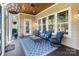 Charming screened porch with cozy seating and a beautiful view of the landscaped backyard at 230 Washam Rd, Mooresville, NC 28117