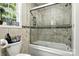 Bathroom featuring glass enclosed tub with tile surround and decorative shelving at 2367 24Th Street Ne Ln, Hickory, NC 28601