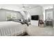 Large bedroom features neutral paint, carpet, a ceiling fan, and a TV on dresser at 2367 24Th Street Ne Ln, Hickory, NC 28601
