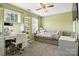 Green bedroom with daybed and desk with rolling chair underneath window at 2367 24Th Street Ne Ln, Hickory, NC 28601