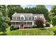 Charming two-story home with a brick-accented porch, black shutters, and lush green lawn at 2367 24Th Street Ne Ln, Hickory, NC 28601