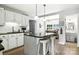 Bright kitchen features an island with bar seating, granite countertops, and white cabinets at 2367 24Th Street Ne Ln, Hickory, NC 28601