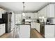 Bright kitchen featuring stainless steel appliances, white cabinetry, and a center island at 2367 24Th Street Ne Ln, Hickory, NC 28601