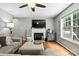 Bright living room with fireplace, ceiling fan, and hardwood floors, perfect for relaxing and entertaining at 2367 24Th Street Ne Ln, Hickory, NC 28601