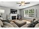 Cozy living room with fireplace, ceiling fan, and large window overlooking the backyard at 2367 24Th Street Ne Ln, Hickory, NC 28601
