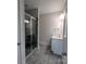 Bright bathroom featuring a tile floor, glass shower door, white cabinets and single sink vanity at 259 Luray Way # 443, Rock Hill, SC 29730