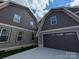 Exterior showcasing the roof line of 2 attached homes with a dark brown three car garage at 259 Luray Way # 443, Rock Hill, SC 29730