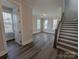 Open-concept living room showcasing lots of natural light, hardwood floors, and access to stairs at 259 Luray Way # 443, Rock Hill, SC 29730