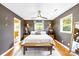 Cozy bedroom with dark grey walls, hardwood floors, and bright natural light at 2919 Dunaire Dr, Charlotte, NC 28205