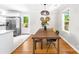 Bright dining area featuring hardwood floors, natural light, and stainless steel refrigerator at 2919 Dunaire Dr, Charlotte, NC 28205