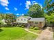Charming two-story home with a brick-and-siding facade, landscaped front yard, and inviting blue front door at 2919 Dunaire Dr, Charlotte, NC 28205