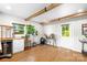 Bright living room featuring wood beams, flooring, cabinetry, and a beverage cooler for convenient entertaining at 2919 Dunaire Dr, Charlotte, NC 28205