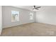 An empty bedroom is bathed in light from two windows, with neutral carpeted floors at 331 Gaines Rd, Clover, SC 29710