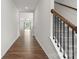 Bright hallway with hardwood floors and staircase with iron railings at 331 Gaines Rd, Clover, SC 29710