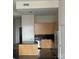 Contemporary kitchen with sleek, light wood cabinets, black tile backsplash, and stainless steel appliances at 333 W Trade St # 505, Charlotte, NC 28202