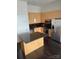 Bright kitchen featuring an island with granite countertops, stainless steel appliances, and wood cabinetry at 333 W Trade St # 505, Charlotte, NC 28202