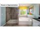 Modern bathroom featuring a glass-enclosed shower, soaking tub, and large window for natural light at 4266 Sylvan Pond Ct, Denver, NC 28037